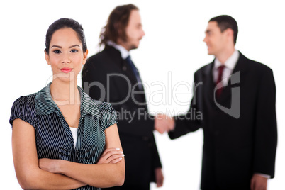 Smiling business women in focus with two business collegue welcoming each other