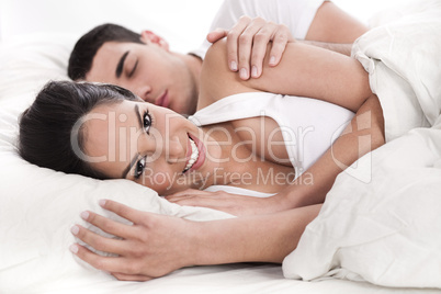Loving husband and wife lying in bed