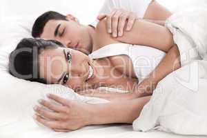 Loving husband and wife lying in bed