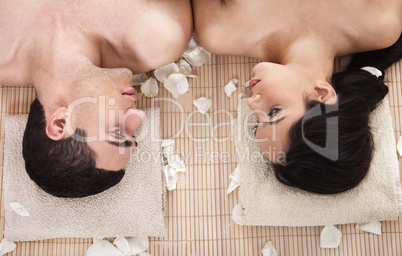 Lovely couple looking eachother during spa treatment