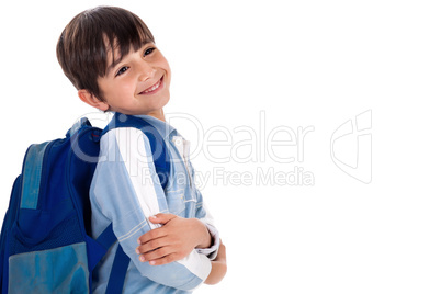 Happy young boy ready for school with his bag