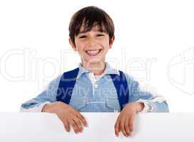 Smiling young boy behind the blank board