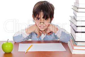 Studying young boy gives strange look wearing specs