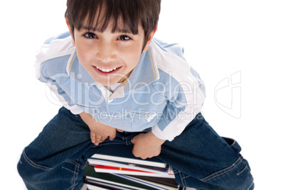 Top angle image of kid sitting on books