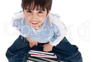 Top angle image of kid sitting on books
