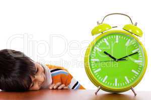 Boy tired of study and sleeping near the clock