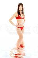 red bikini brunette in water