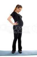 lovely pregnant woman in black working out