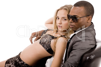 Sexy lady lying on the young business man in couch