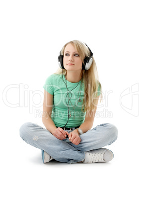 teenage girl in headphones sitting on the floor