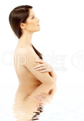 topless brunette in water