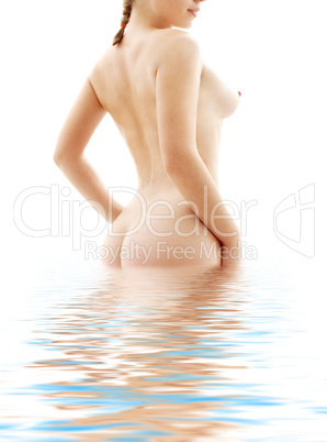 naked woman standing in blue water