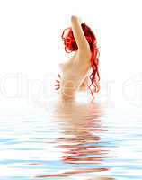 topless redhead in blue water