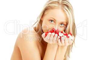 lovely blond in spa with red and white rose petals