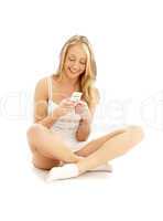 teenage girl sitting on the floor with a white phone #2