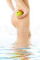 naked woman with green apple in water