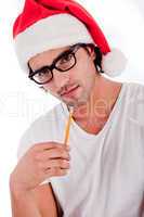 handsome man thinking by wearing santa's hat