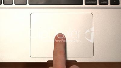 Demonstrating the various uses of a laptop's multi-gesture trackpad.