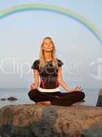 meditation at the seashore under rainbow