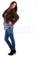 Pretty model posing wearing blue jean, matching top and a fur coat
