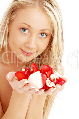 happy blond in spa with red and white rose petals