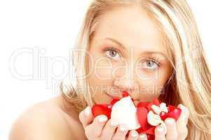 happy blond in spa with red and white petals