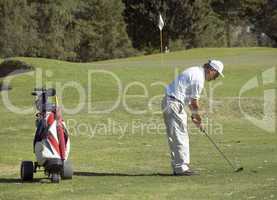 Middle aged senior playing golf