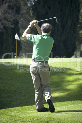 Middle aged senior playing golf