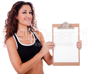 Fitness woman showing a blank clip board