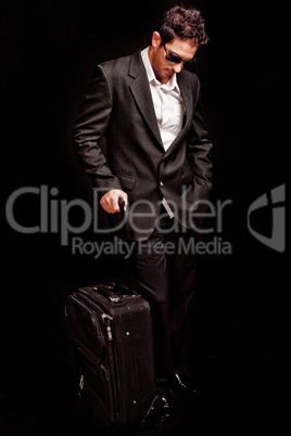 Business man looking down with his luggage