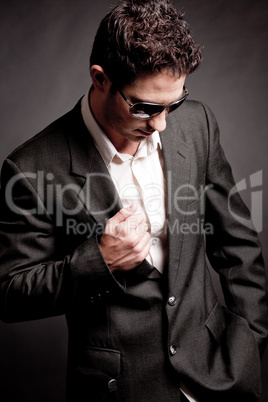 Young business man looking down wearing sunglasses