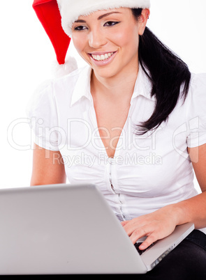 Young santa girl browsing the net