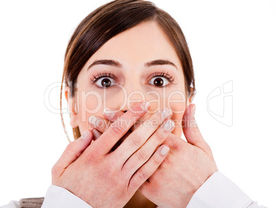 Closeup of young women covering her mouth with both hands