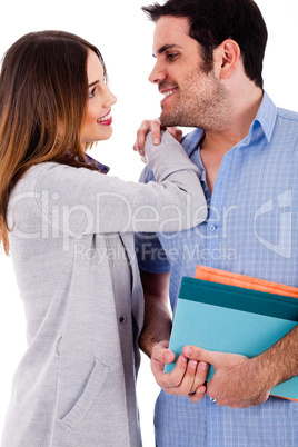 Lovers smiling at each other with the man books in this hand