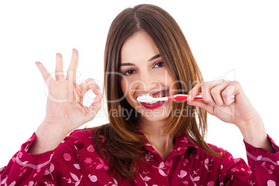 Women brushing her teeth and showing perfect gesture