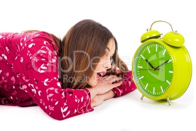 Girl looking into the alarm while its ringing