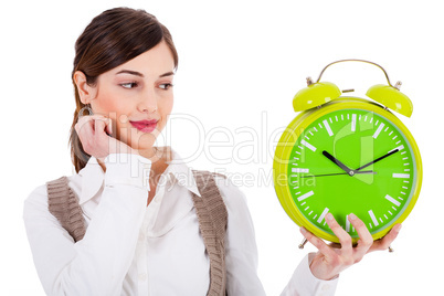 young beautiful brunette holding the clock and seeing