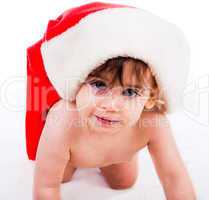 baby in santa hat crawling