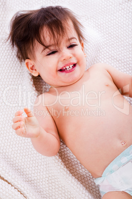 Baby laughing after the bath in a white towel