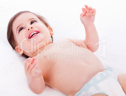 Playful baby lying with has hands up