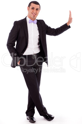 Full body of a business man standing against the wall