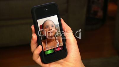Video chatting on a portable handheld device.  Screen images simulated.