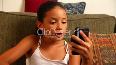 A young girl video chats on her mobile smartphone.