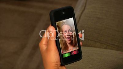 Video chatting on a portable handheld device.  Screen images simulated.