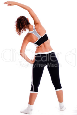Rear view of a Cute fitness girl stretching her body