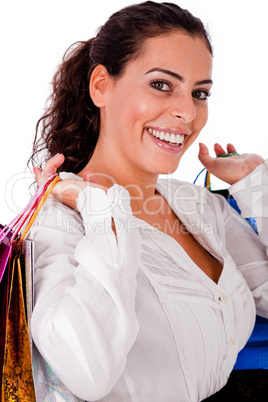 Happy young woman holding shopping bag  in both hands