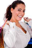 Happy young woman holding shopping bag  in both hands