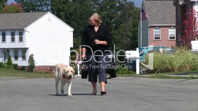 A woman walks her dog.
