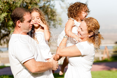 Parents with two kids side view