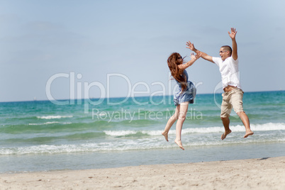 Happy young couple having fun on the beach Happy young couple having fun on the beach